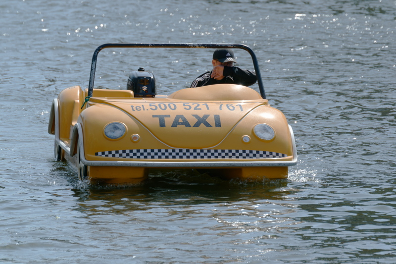 A VW Beetle-shaped water motor pedalo operating on the Motława River in Gdańsk, Poland
